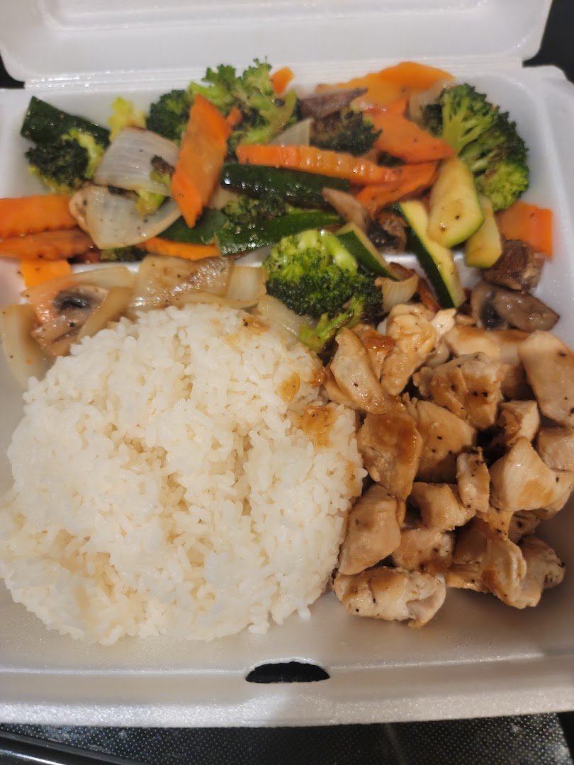 Hibachi meal beside a bowl of soup.